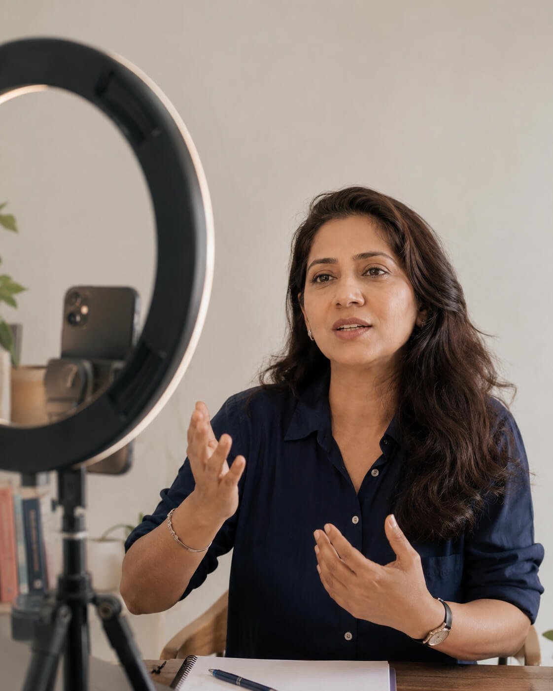 A coach recording to camera in a corner of her home
